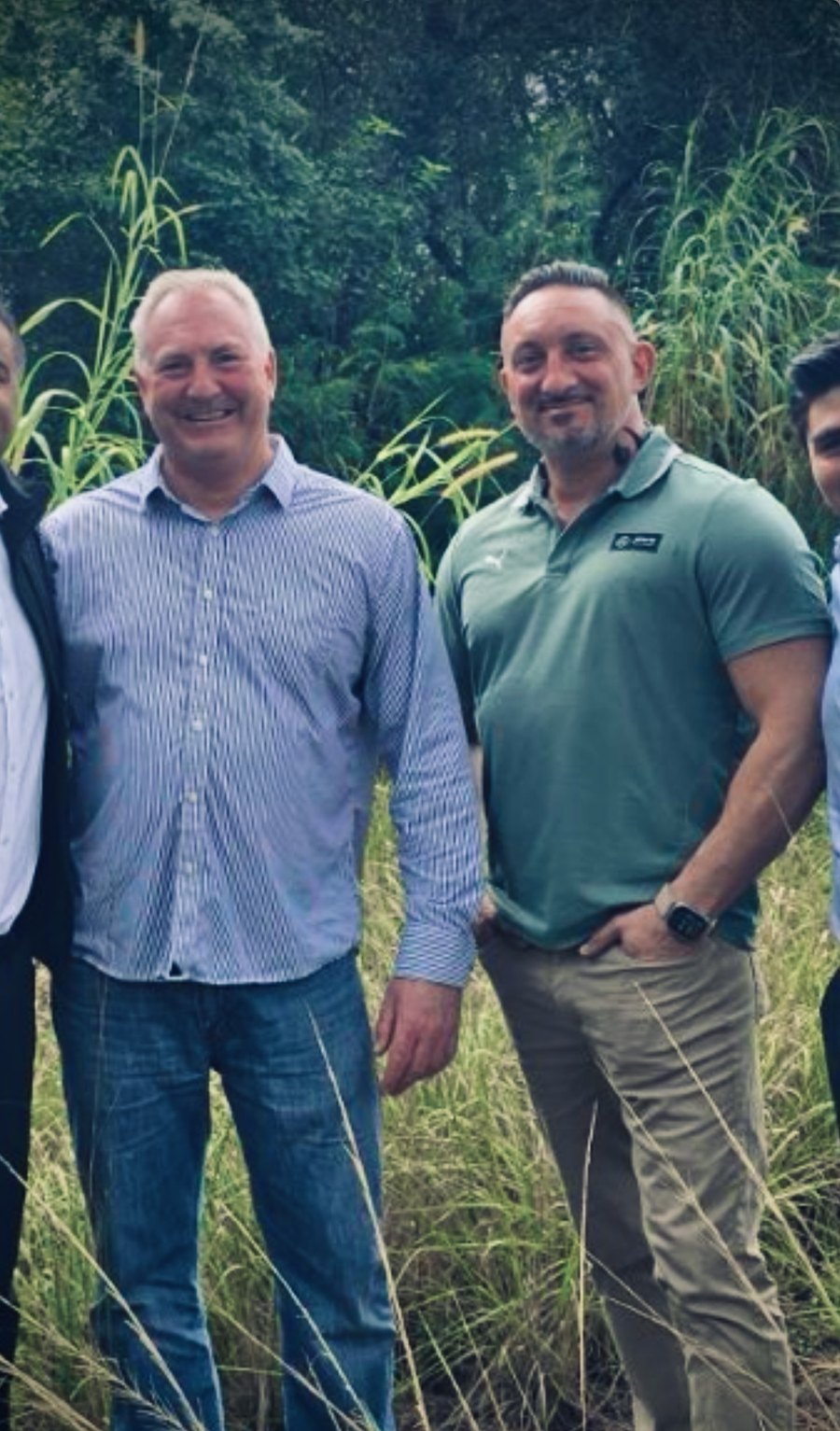 Bill Breunig and Gary Kerber standing in tall grass at a South Florida groundbreaking