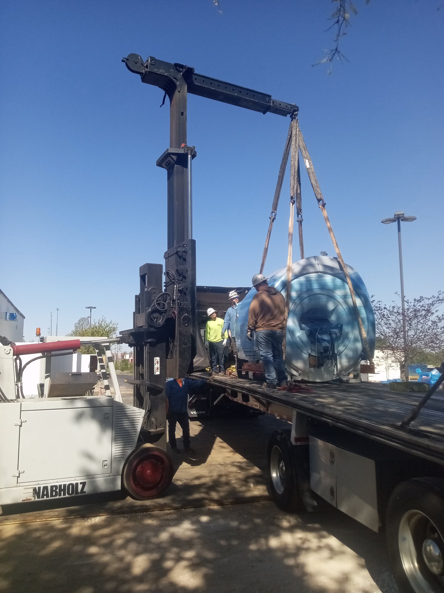 Rigging crew craning imaging equipment into the building