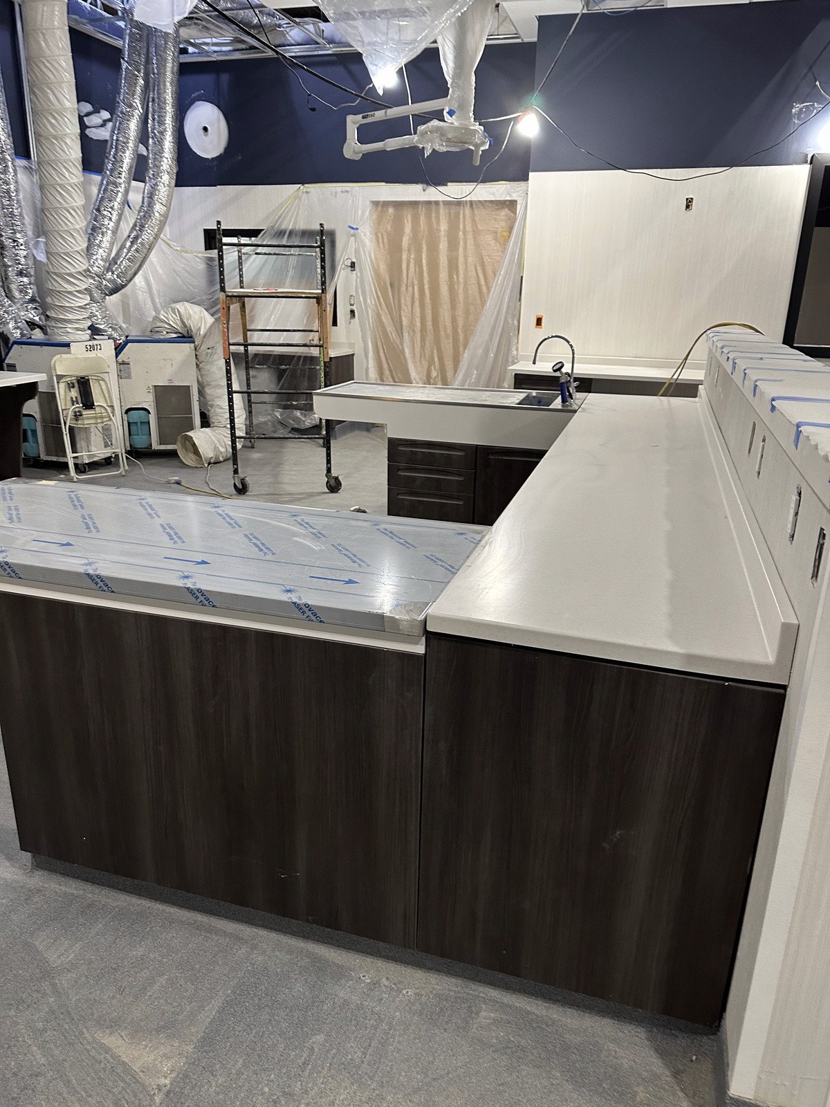 Finished reception desk at the AESC animal hospital, stone front and wood floor