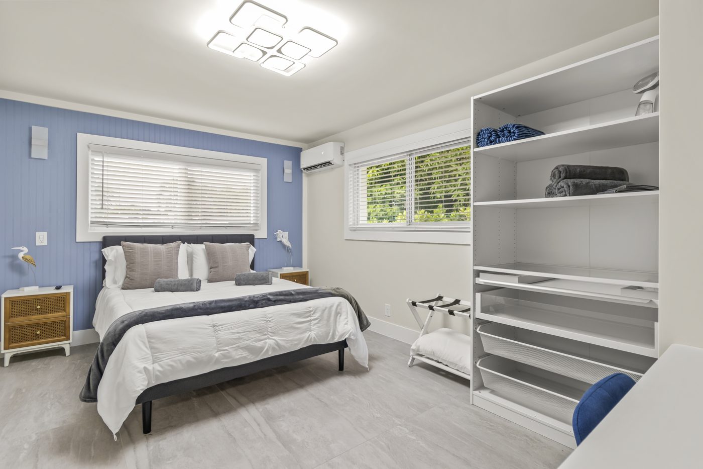 Bedroom with built-in shelving and a queen bed