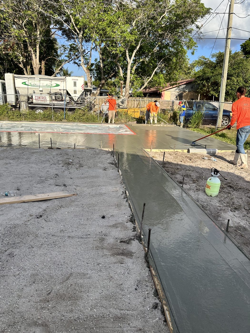 Crew pouring and floating the new concrete pool deck