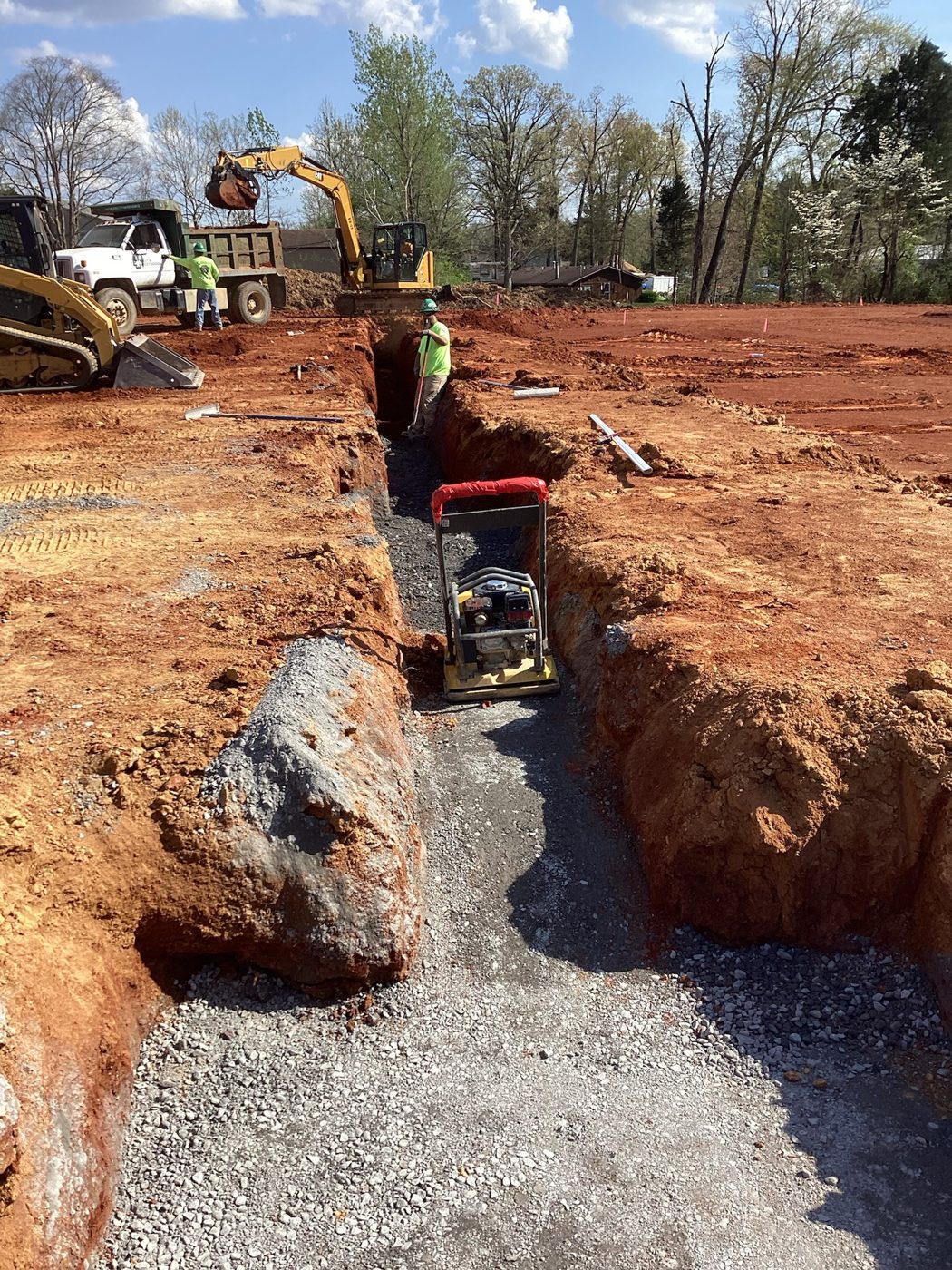 Excavator digging the underground utility trench