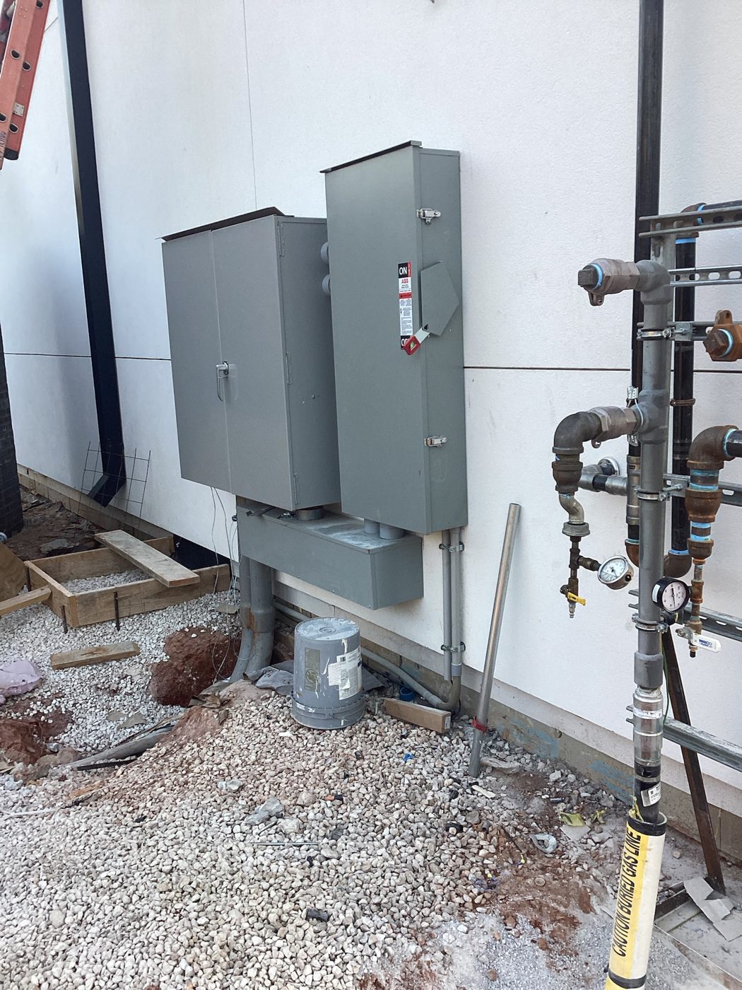 Electrical service panels and gas piping on the exterior wall