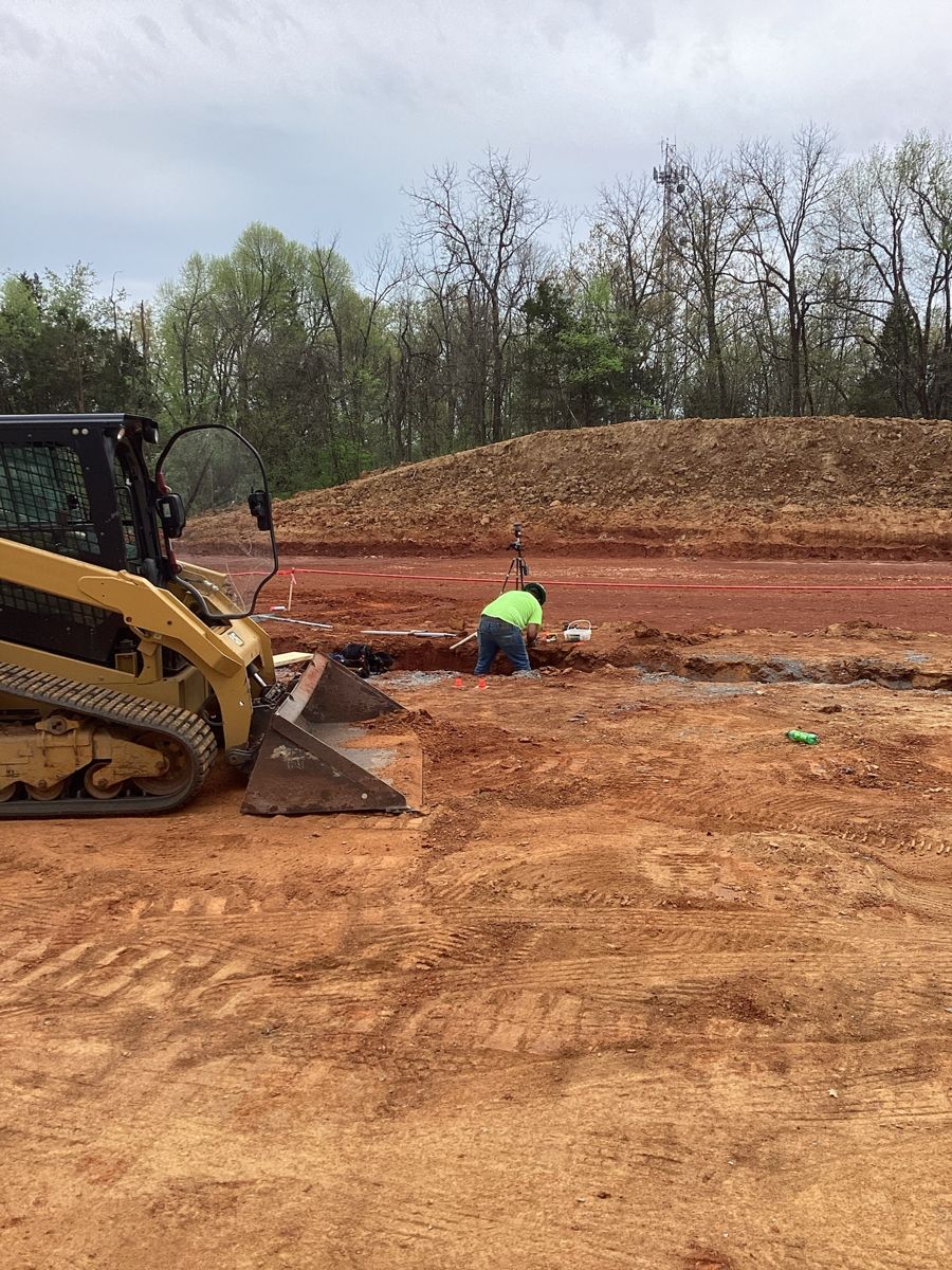 Skid steer grading beside the spoil pile