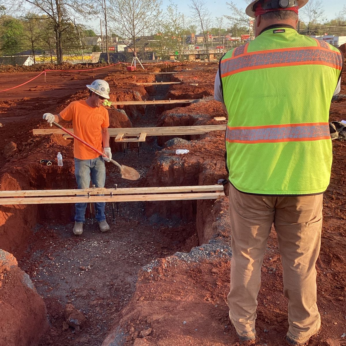 Crew forming footings in the excavated trenches