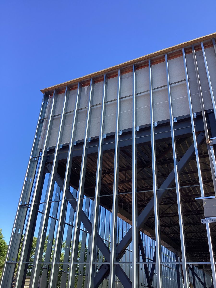 Exterior metal studs rising against a blue sky