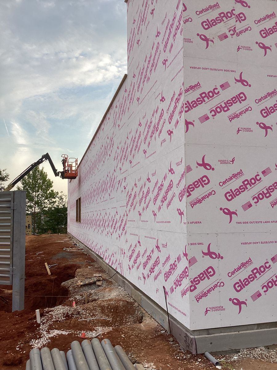 Pink exterior sheathing panels going on the walls