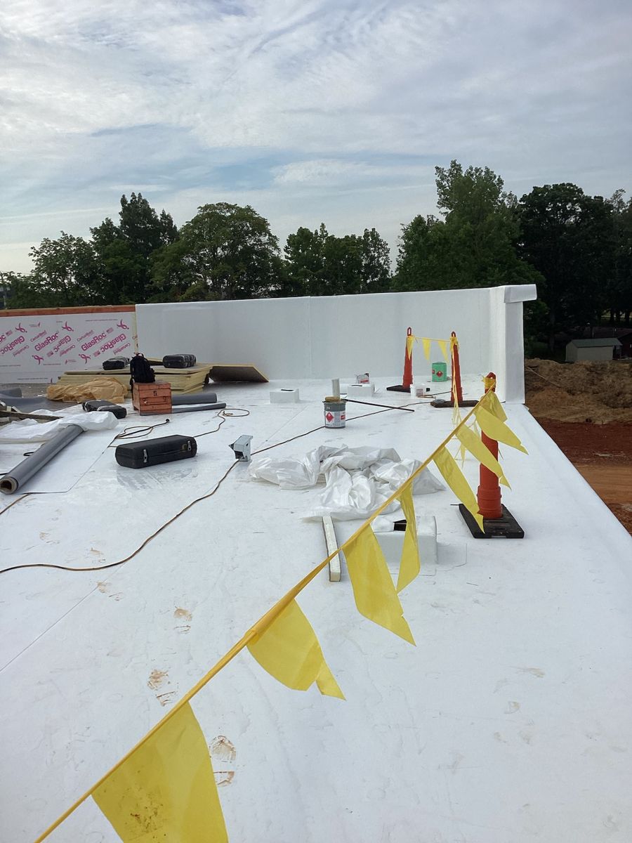 White TPO roof membrane with safety flagging