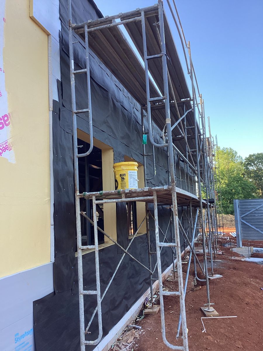 Scaffold at the dark panel section of the exterior