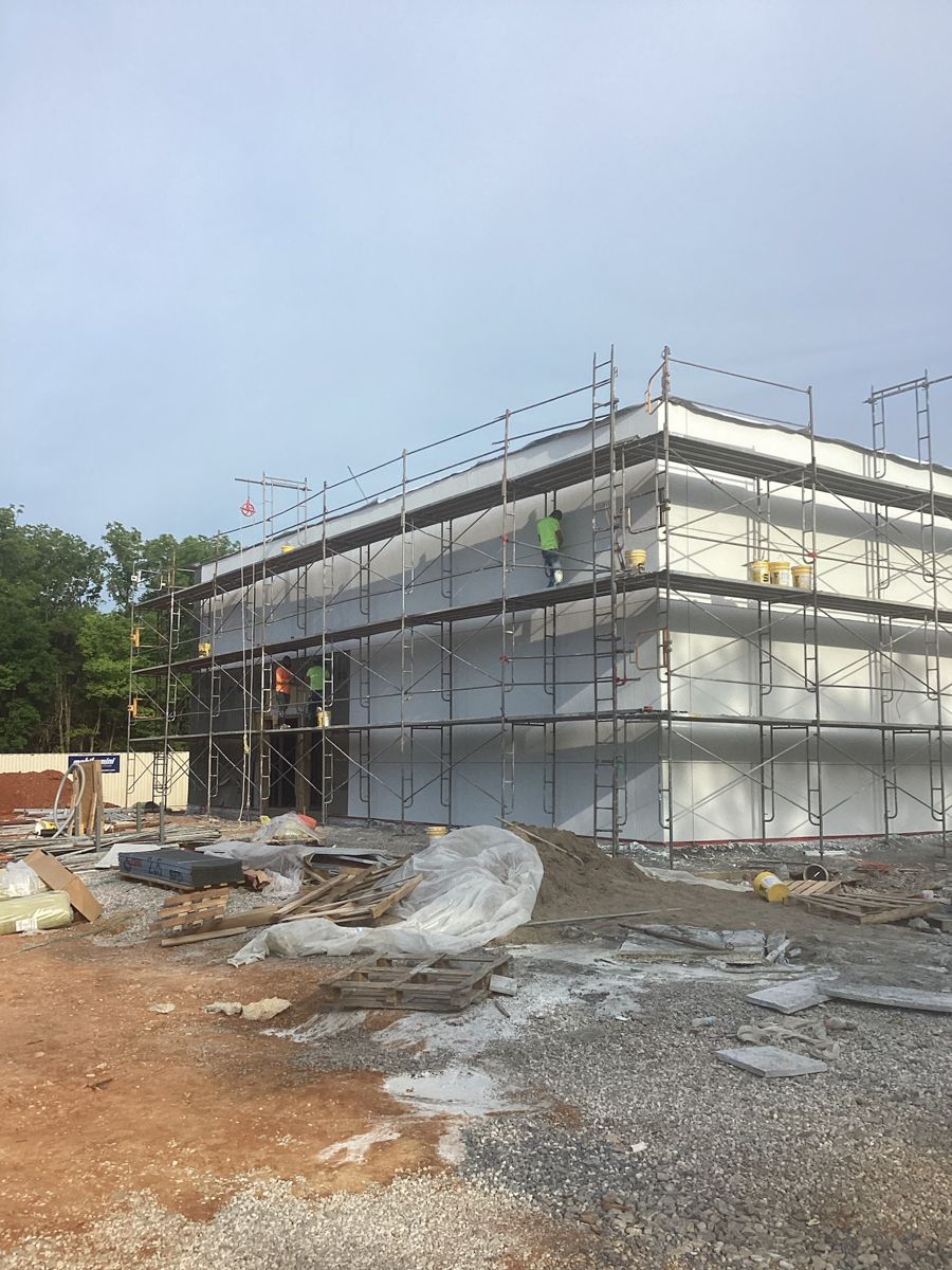 Exterior envelope finished in white, scaffold coming down
