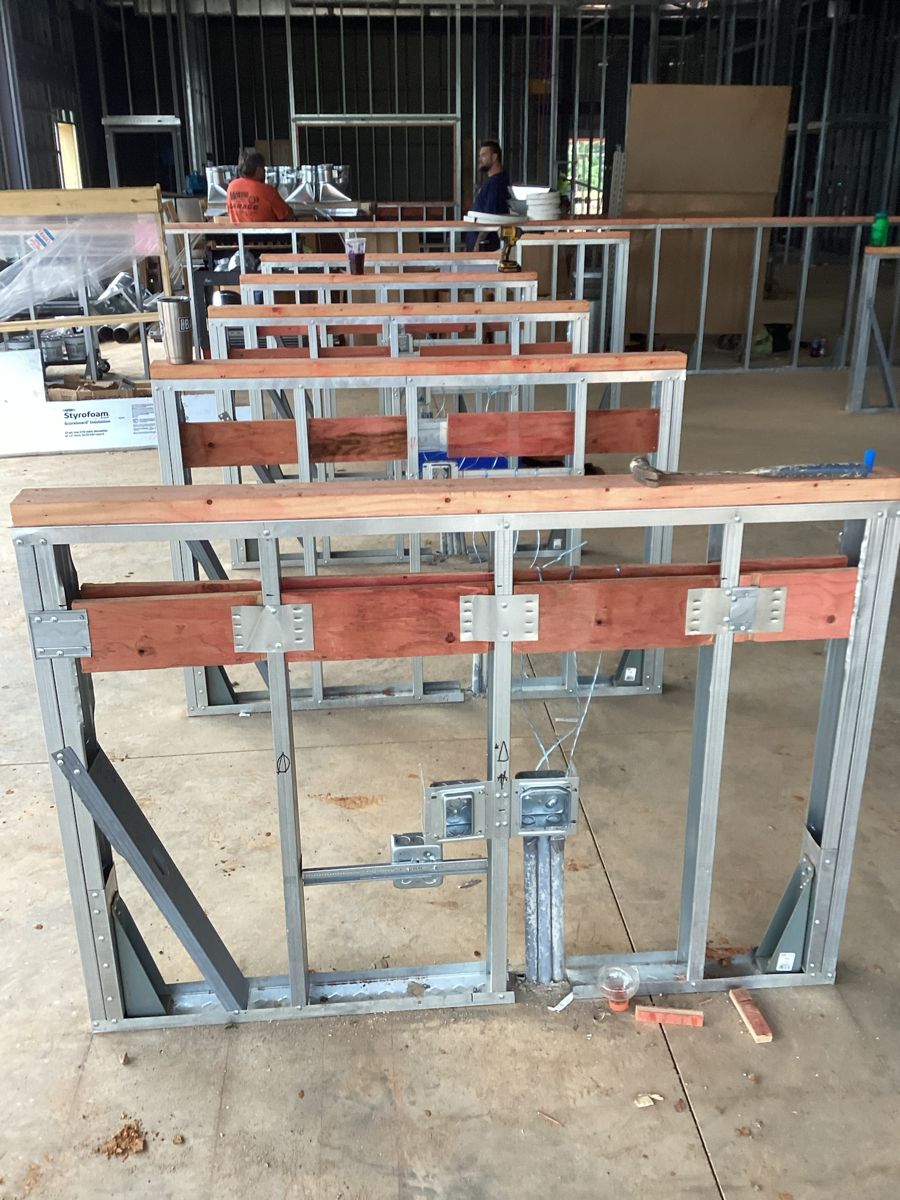 Interior metal stud framing at the front counter, plywood base in place