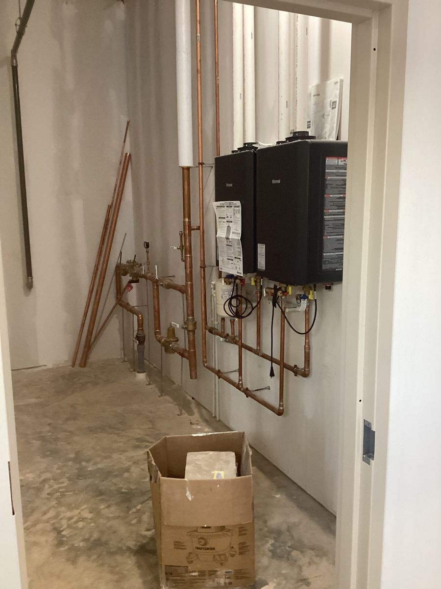 Copper piping and water heater in the mechanical closet