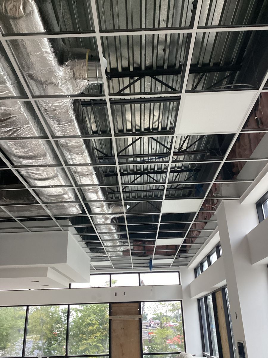 Ceiling grid and ductwork over the main room near the windows