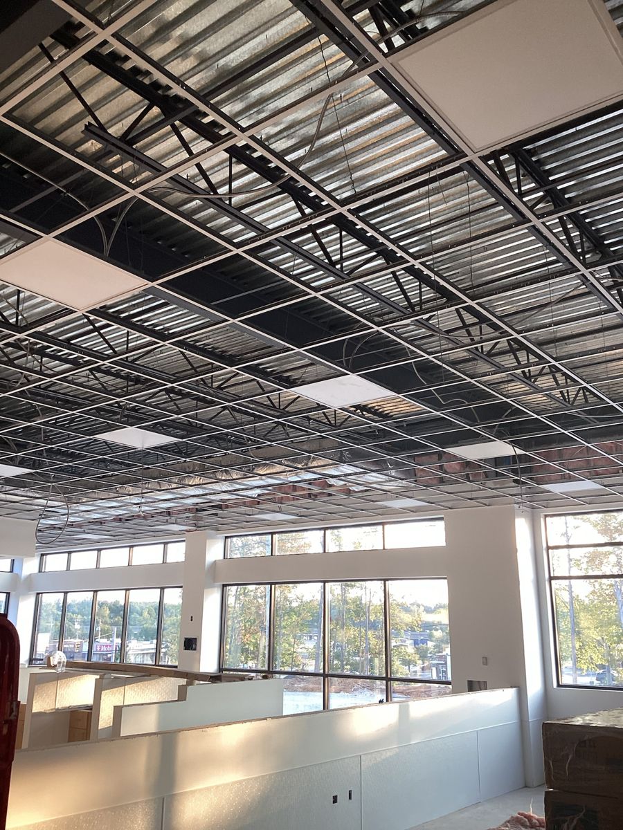 Suspended ceiling grid across the main room, tiles not yet set