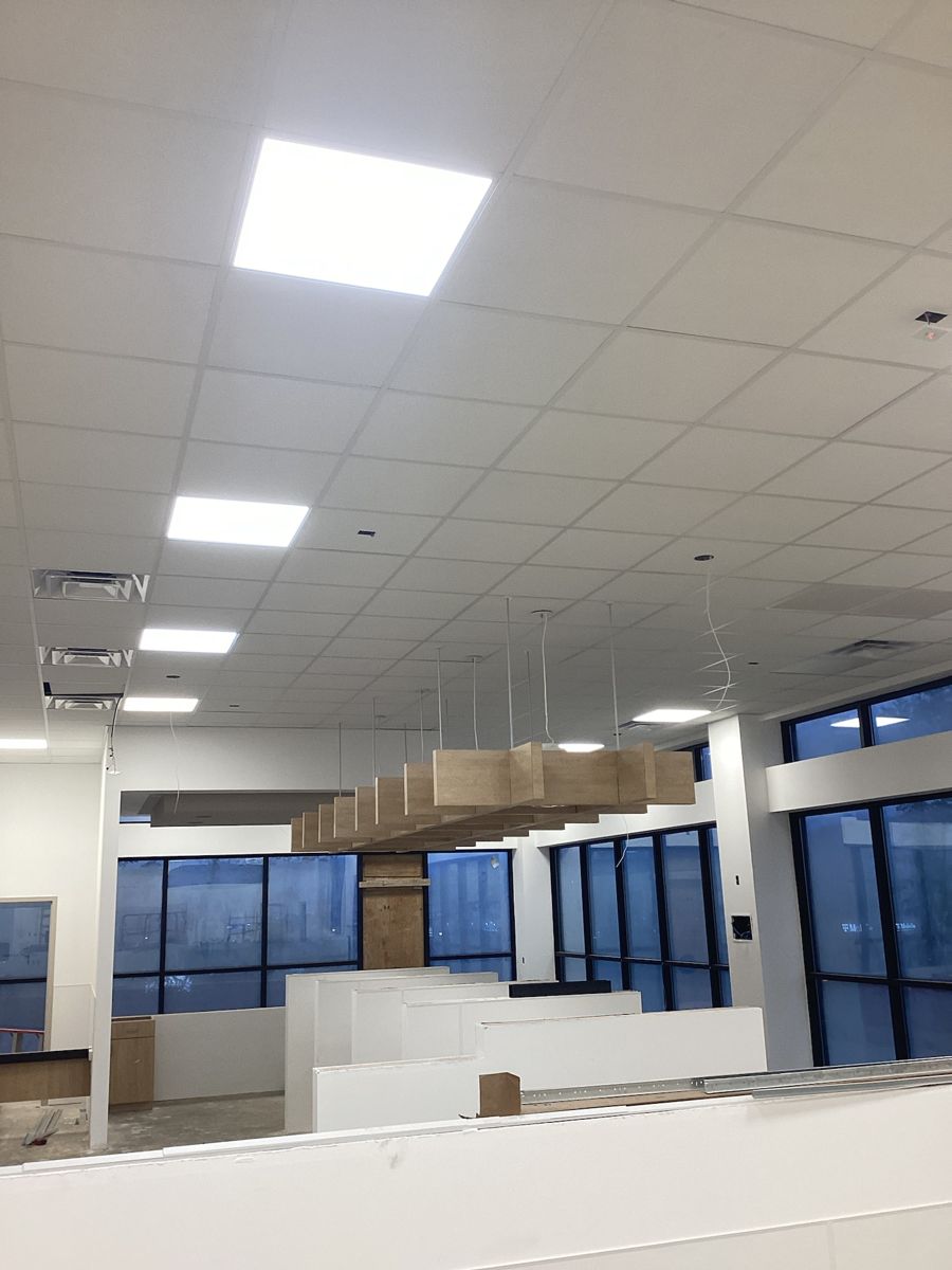Finished ceiling tiles and lighting in the main room