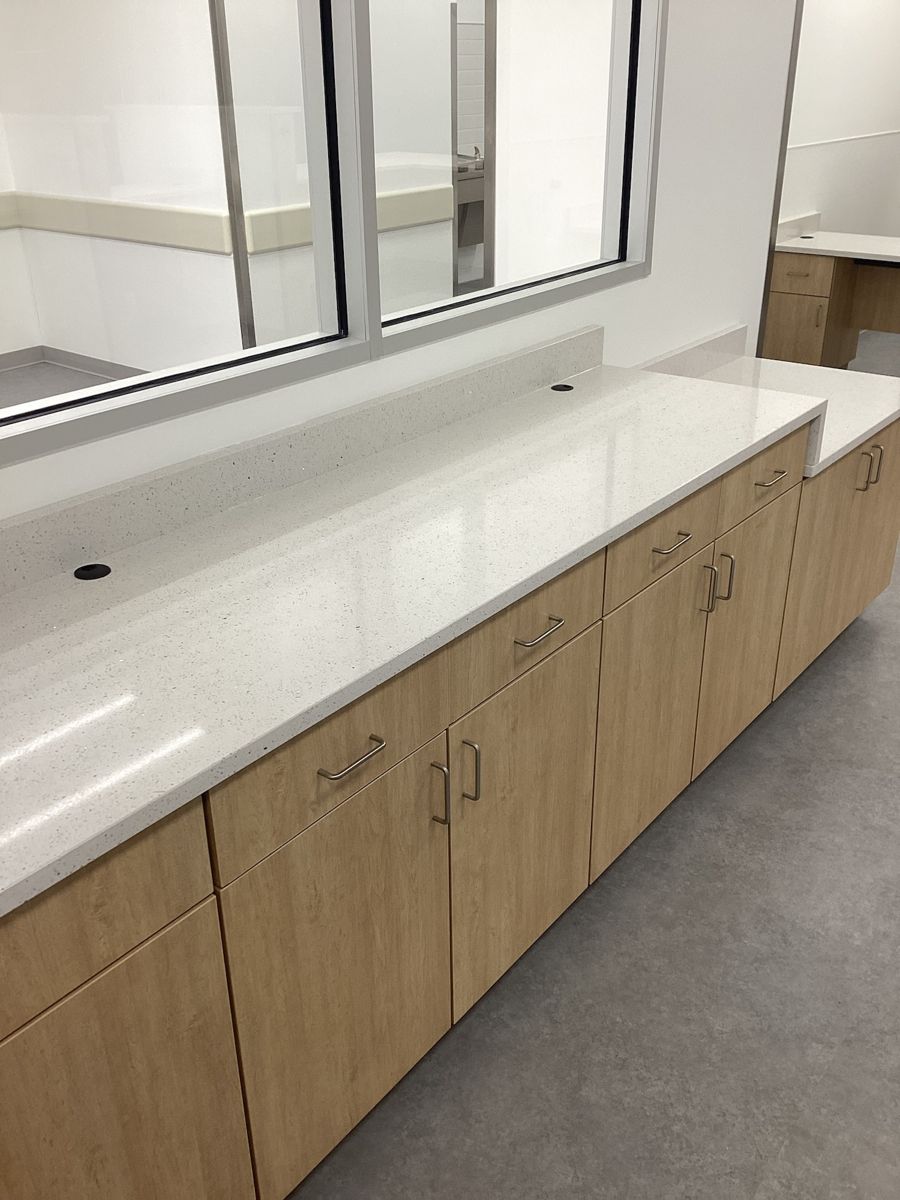 Wood casework and countertop below a pass-through window