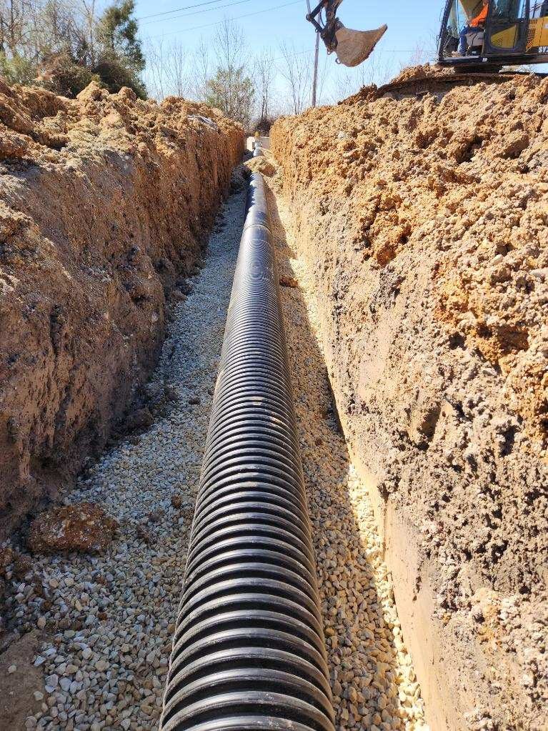New underground utilities being installed on the cleared lot