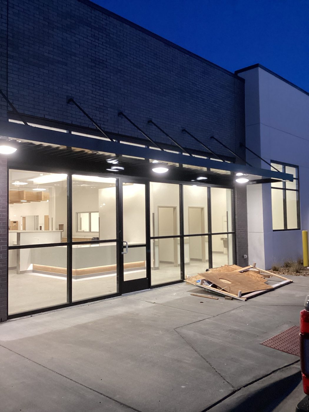 Glass storefront lit at dusk