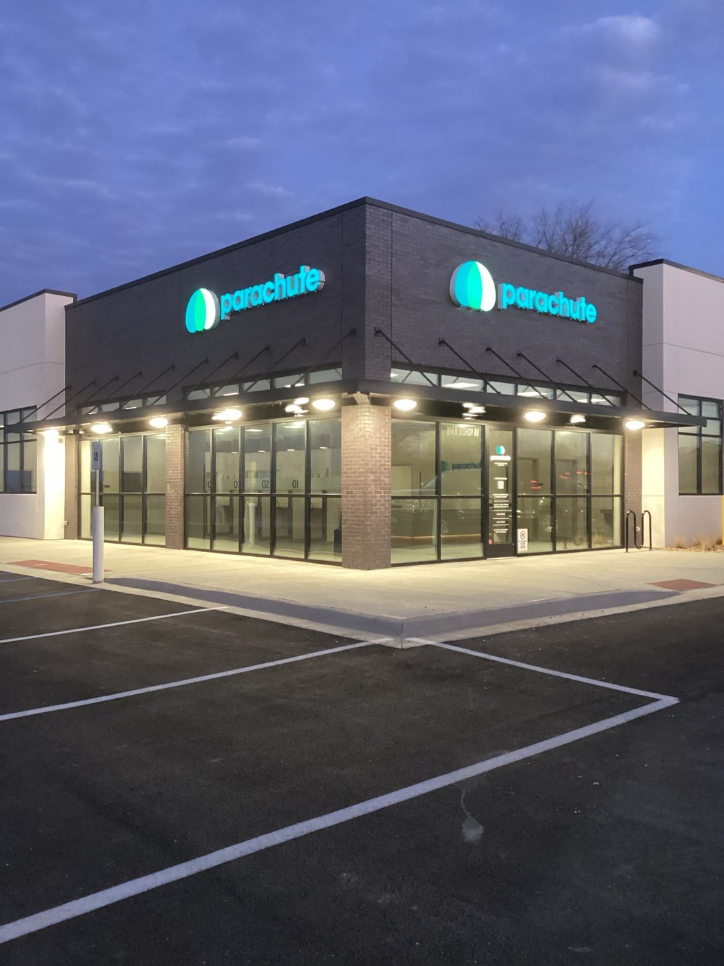 Finished Parachute plasma donation center at dusk, storefront lit