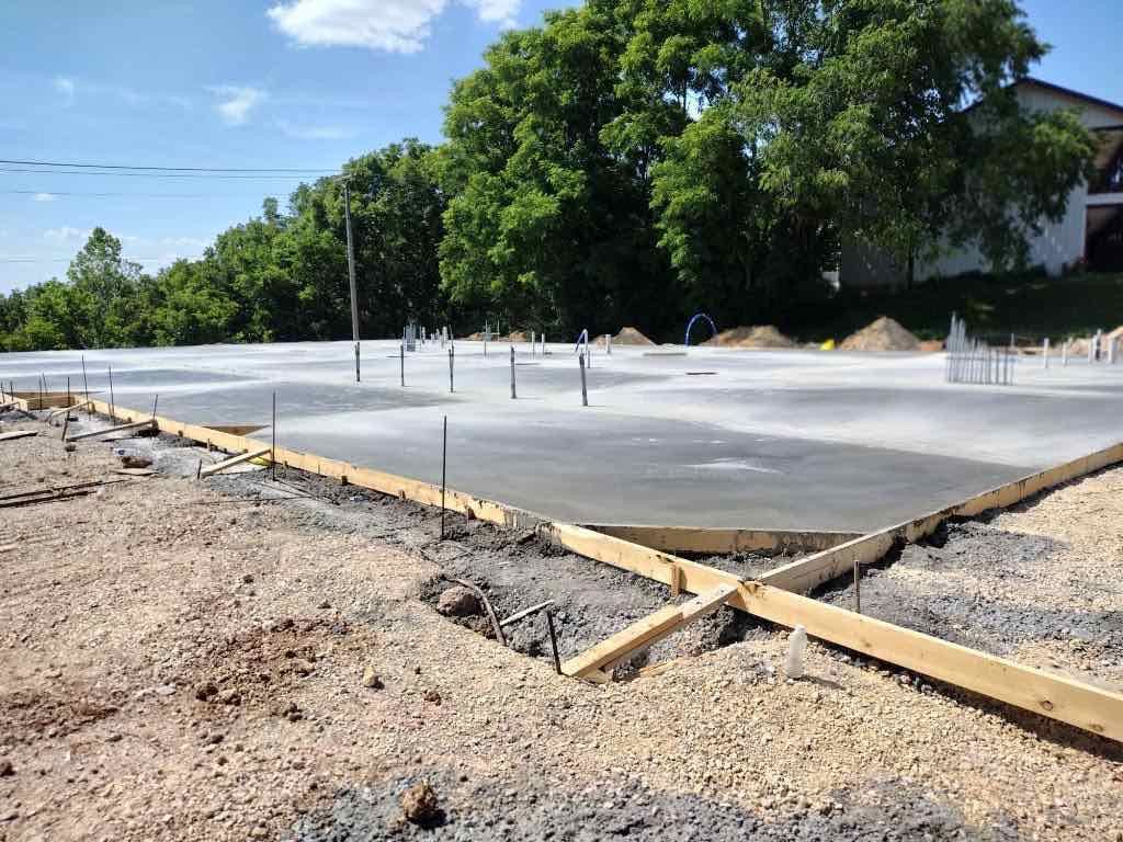 Freshly poured concrete slab with utility stubs in place