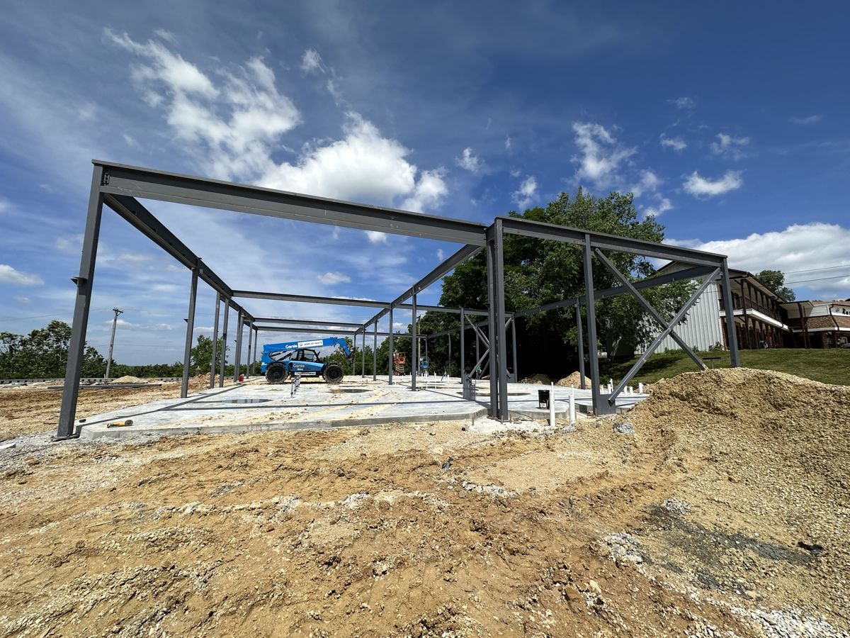 Structural steel frame with beams set against a blue sky