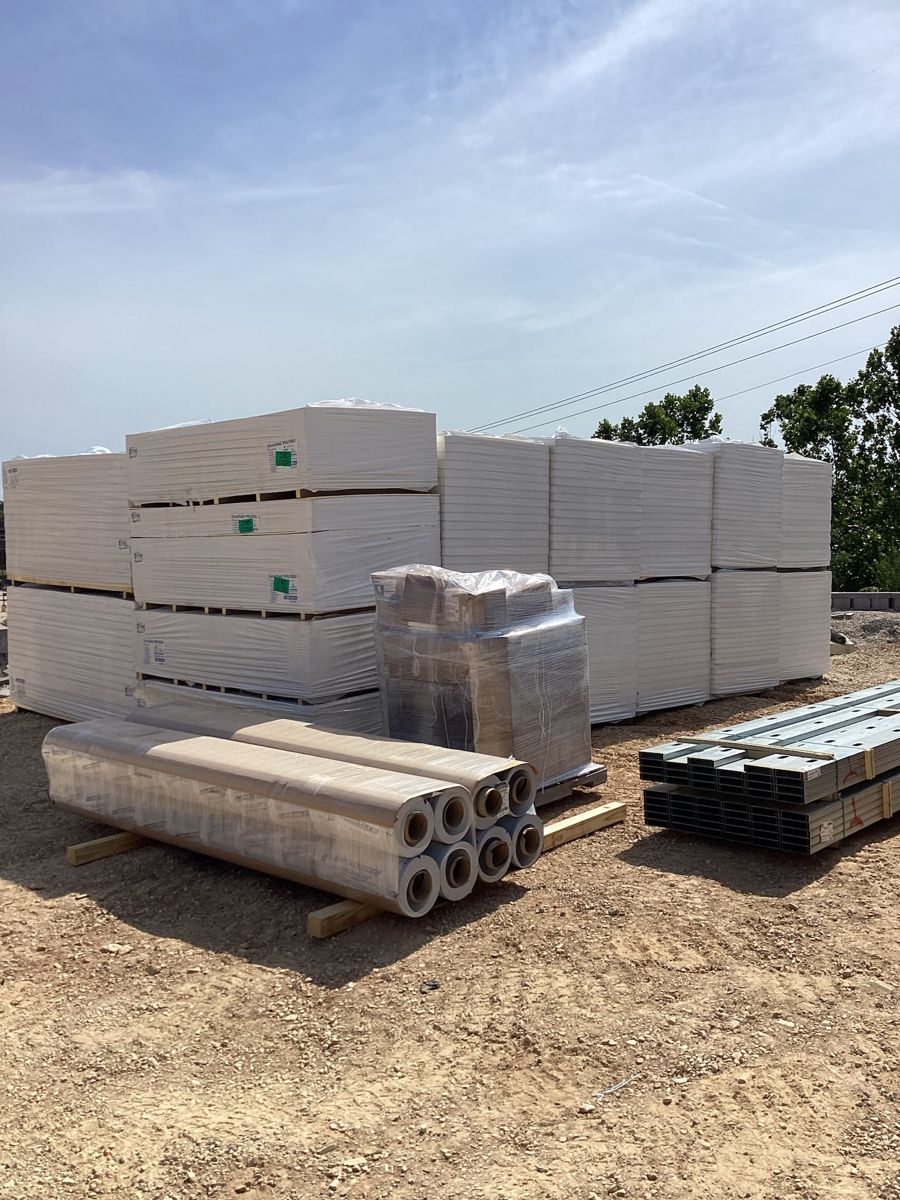 Drywall, insulation and framing stock staged on site