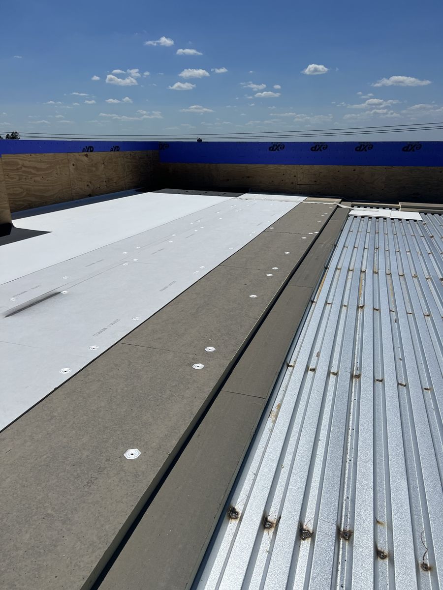 Roof insulation and cover board laid over the metal deck