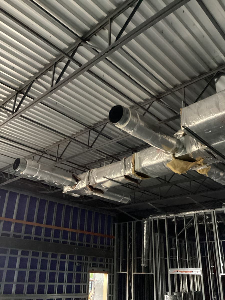 Insulated ductwork hung from the roof structure