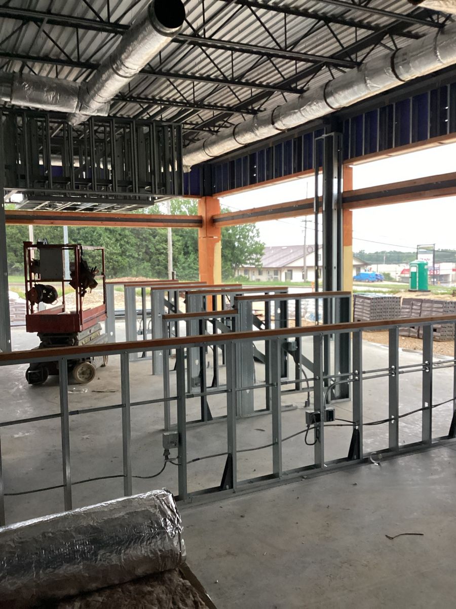 Interior partition framing with a scissor lift on the slab