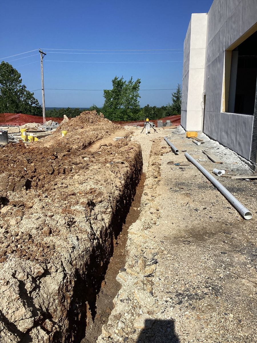 Utility trench cut beside the finished exterior wall