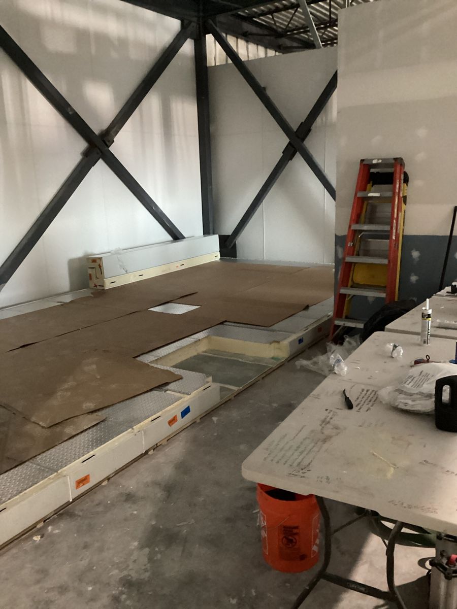 Insulated floor panels for the walk-in cold room being set