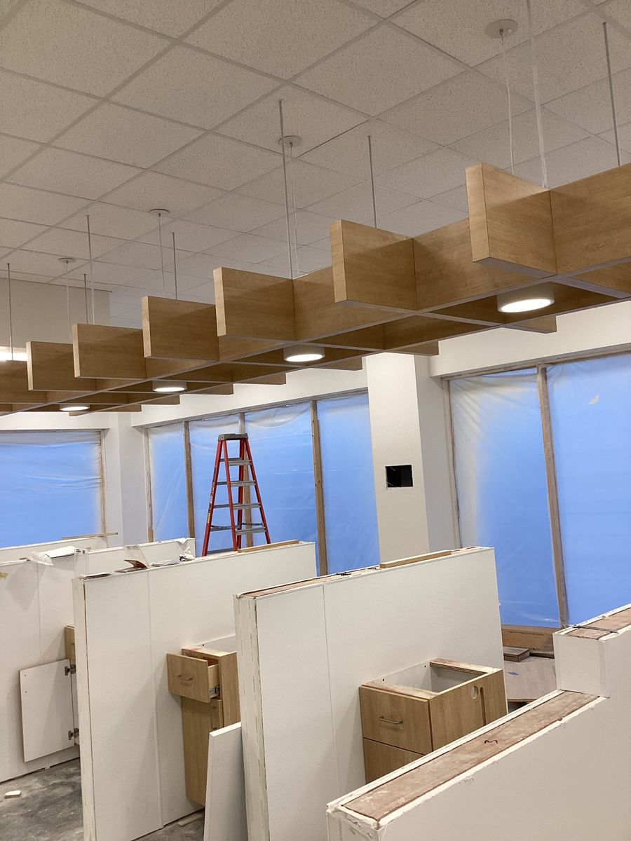 Wood baffle ceiling feature installed over the donor stations