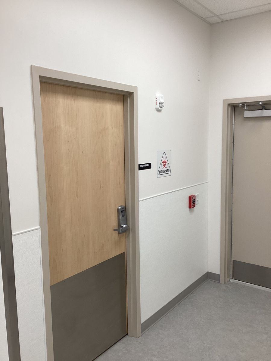 Keypad-locked biohazard room door in the finished corridor