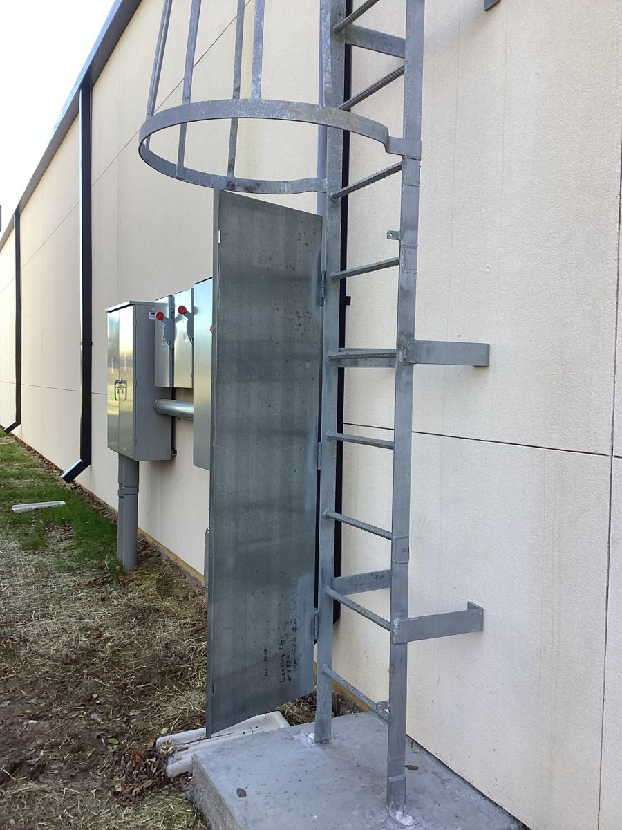 Roof access ladder and electrical disconnects on the exterior wall