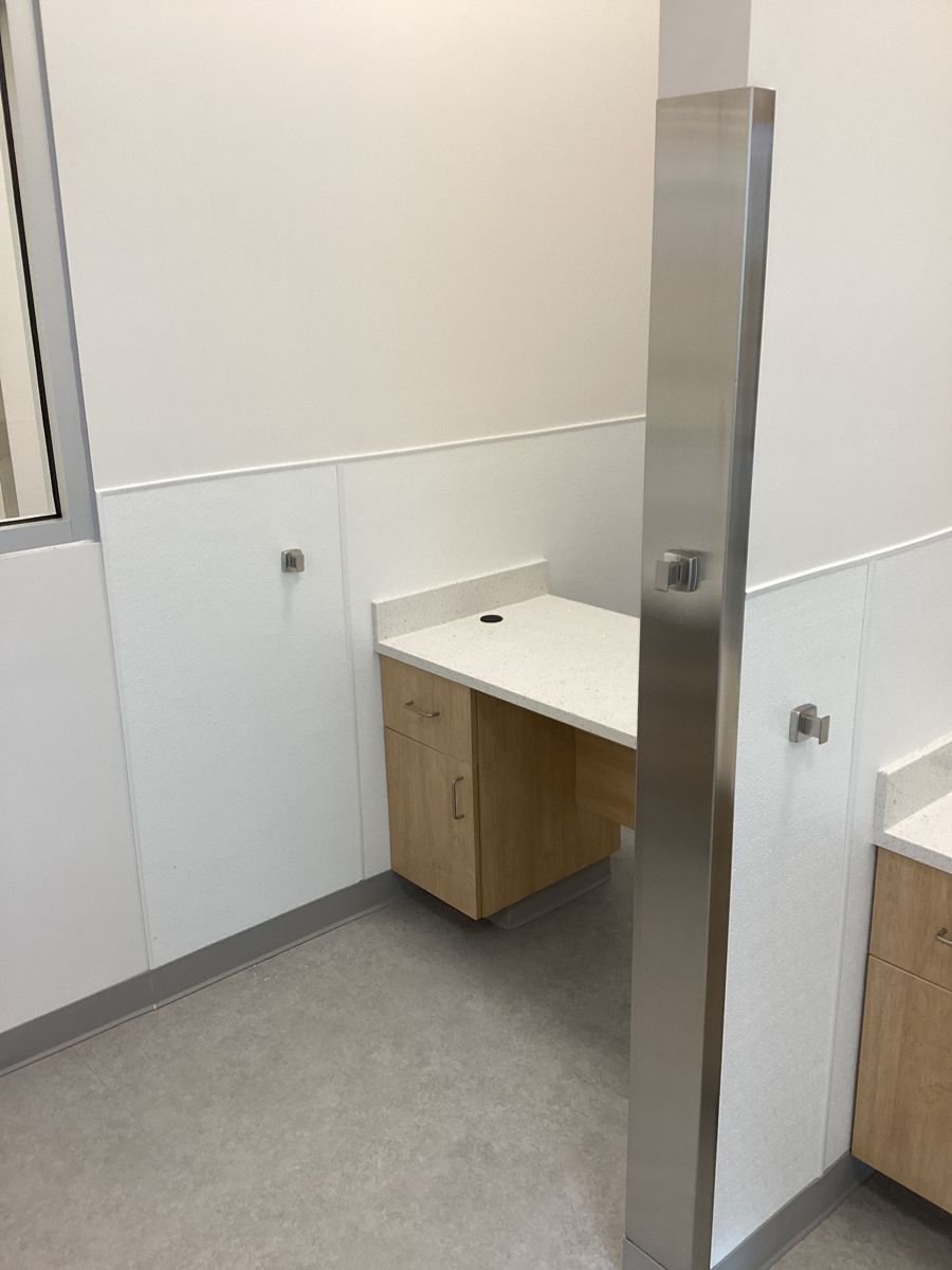 Screening cubicle with quartz counter and stainless corner guard
